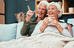 Couple in retirement, elderly and watch television on couch at family home, relax with funny tv show or movie and excited with happiness and coffee. Retired, old man and old woman happy together.