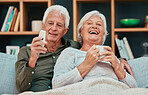 Elderly couple, laugh and relax watching tv with coffee on the living room sofa together at home. Happy senior man and woman relaxing, streaming and laughing for entertainment, movie or show on couch