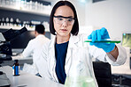Scientist, woman with test tube and science test in lab, chemical liquid for experiment and doctor with research for scientific innovation. Chemistry, focus and chemical liquid in Japanese laboratory