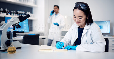 Buy stock photo Researcher, Asian woman and writing in notebook, laboratory and planning schedule. Research, female chemist and at desk with book, smile or journal for science innovation, data analysis or experiment