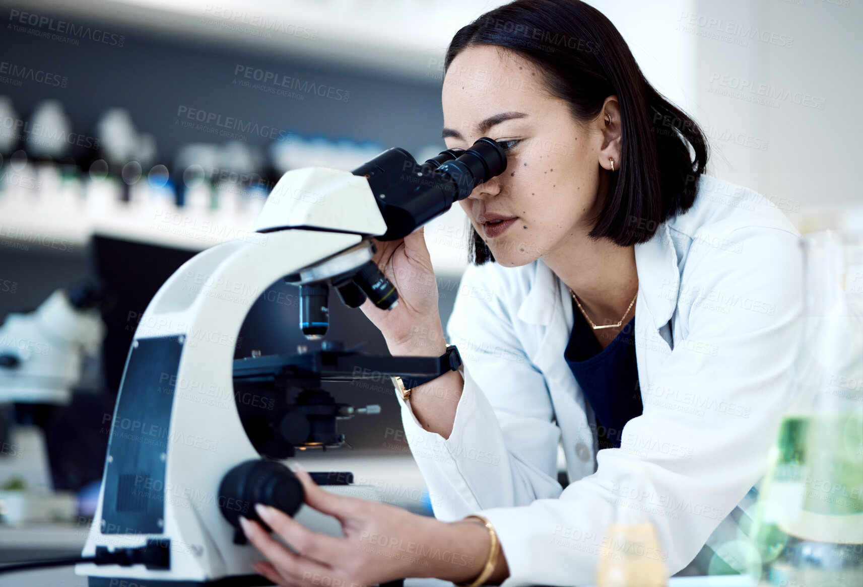 Buy stock photo Microscope, Asian woman and in laboratory for research, innovation and science method for healthcare. Female researcher, lady and medical professional with lab equipment, check sample and results.