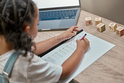 Buy stock photo Girl learning, writing and paper for maths, study and cognitive development in home school with laptop. Young african student, female studying numbers and focus with pen, tech and thinking in house