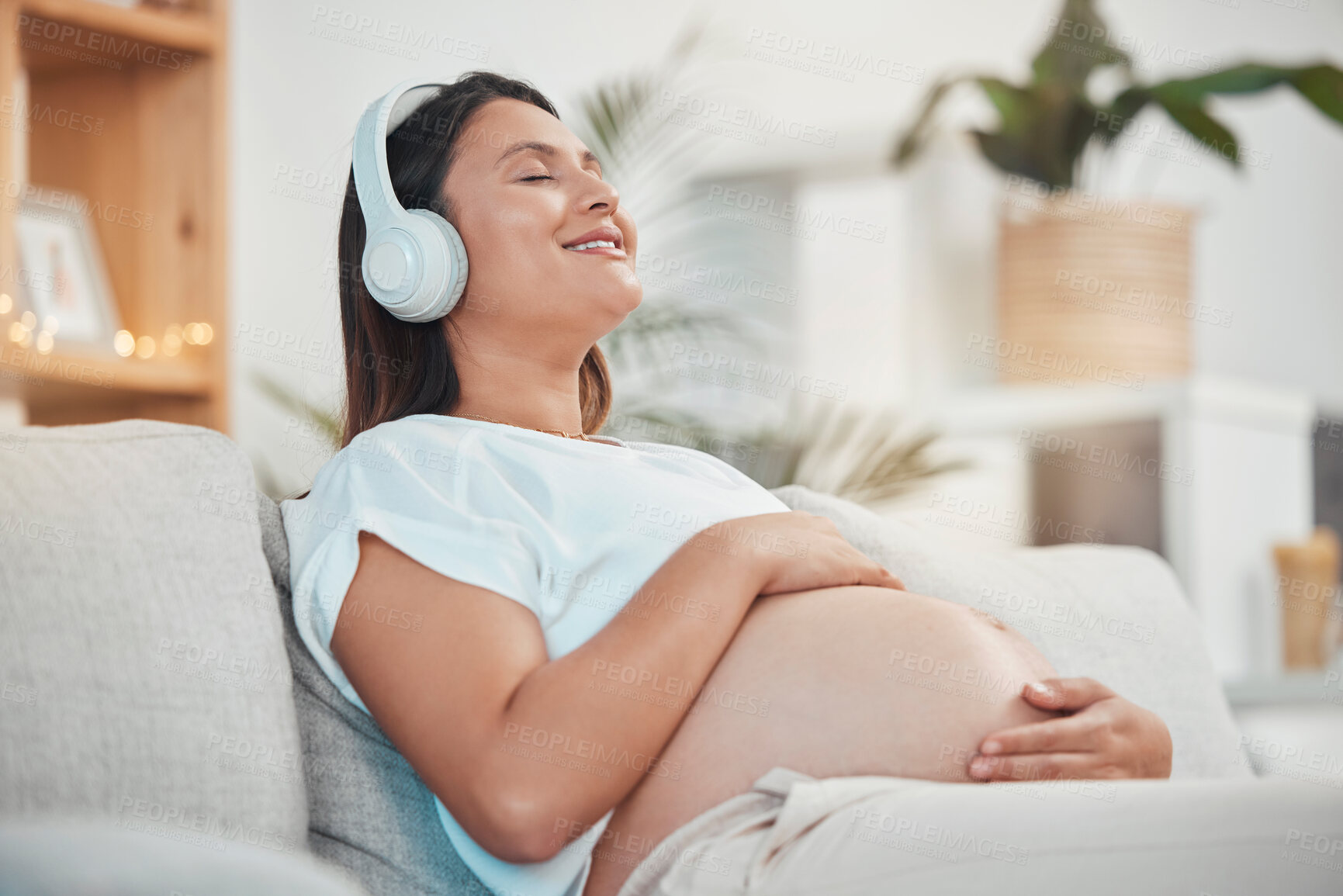 Buy stock photo Music, headphones and pregnant woman relax on sofa in home living room streaming radio or podcast. Pregnancy, meditation and female from Canada on couch listening to song, audio or sound in house.