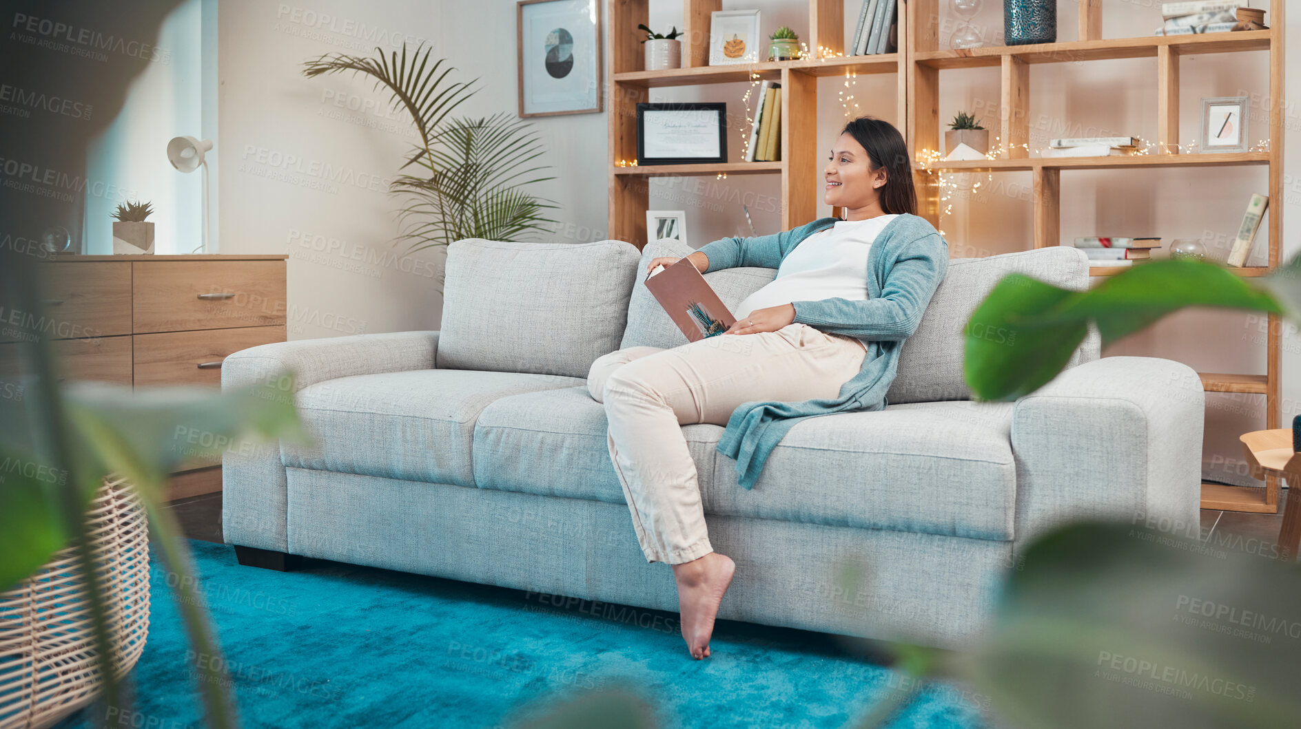 Buy stock photo Pregnant woman, relax and reading book on sofa in home, thinking or contemplating. Pregnancy, idea and female sitting on couch studying literature, fantasy story or novel in lounge of house alone.