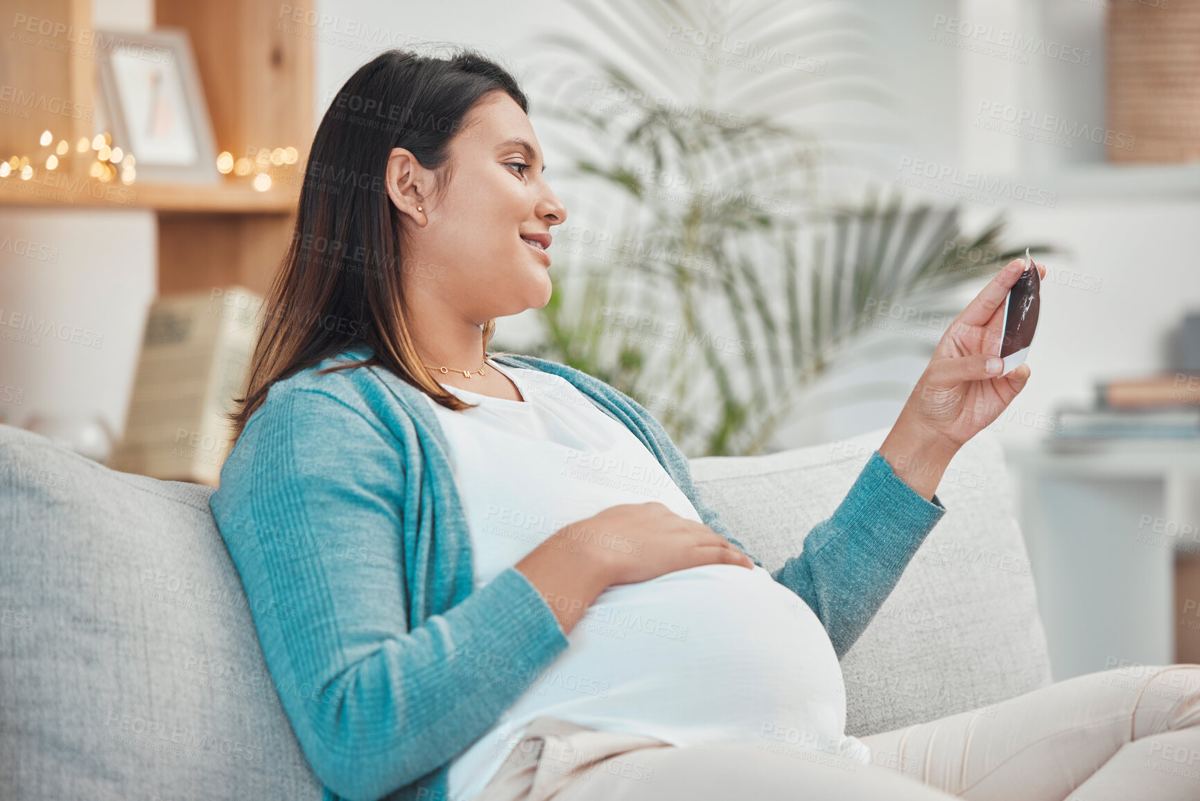 Buy stock photo Pregnant woman, photograph and relax on sofa in living room for peace, calm or energy. New mother, baby and happy smile for child love, ultrasound and pregnancy care or mom relaxing on couch in home