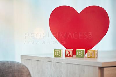 Buy stock photo Heart, sign and baby toy announcement for a kid, child or newborn on a family home table. Love, care and announce or notification in wooden building blocks design for colourful news with a shape 