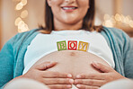 Pregnancy, blocks and hands on stomach for love, childcare and motherhood support. Pregnant woman, happy baby development and mom wellness, healthy maternity growth or calm, relax lifestyle in home