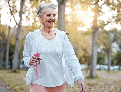 Buy stock photo Fitness, nature and senior woman with water bottle for wellness, hydration and minerals for walking in park. Health, retirement and elderly female doing workout, exercise and cardio training outdoors