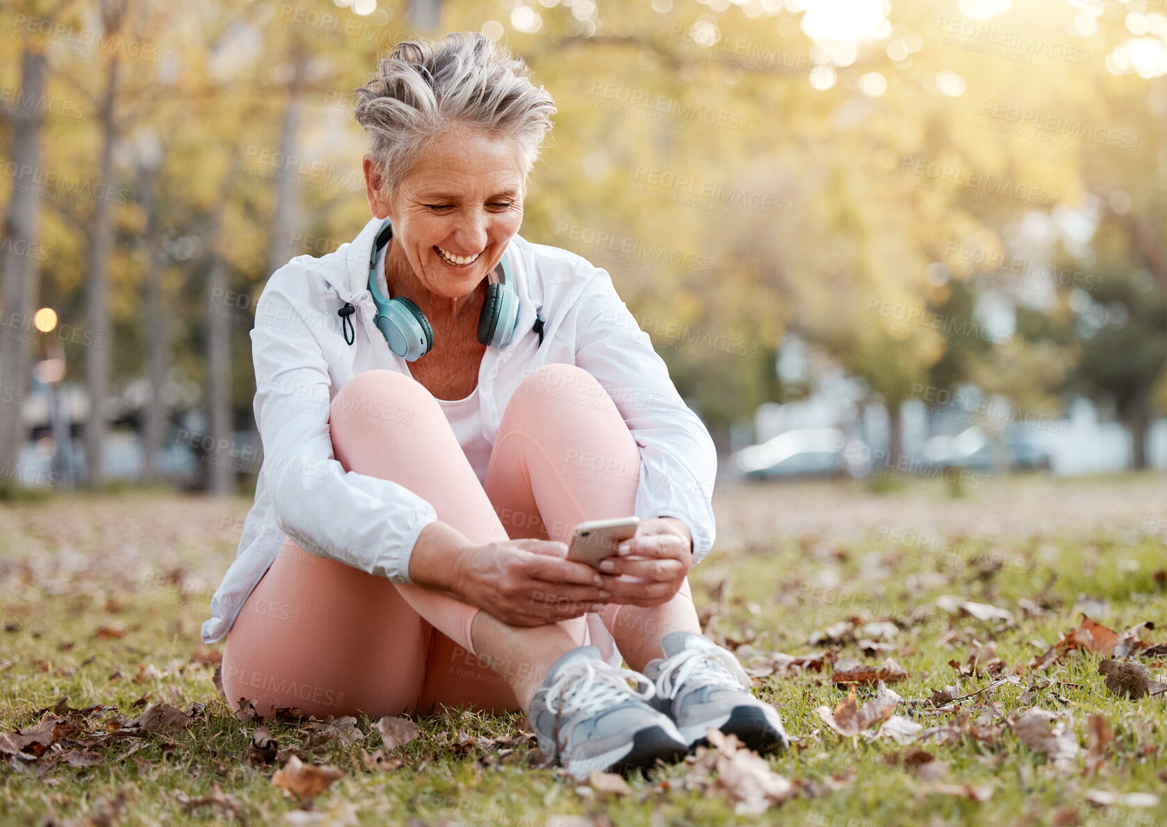 Buy stock photo Smartphone, park and senior woman with nature wellness, mental health app and website blog post for healthy retirement life. Elderly or old woman using phone or typing on cellphone and relax on grass