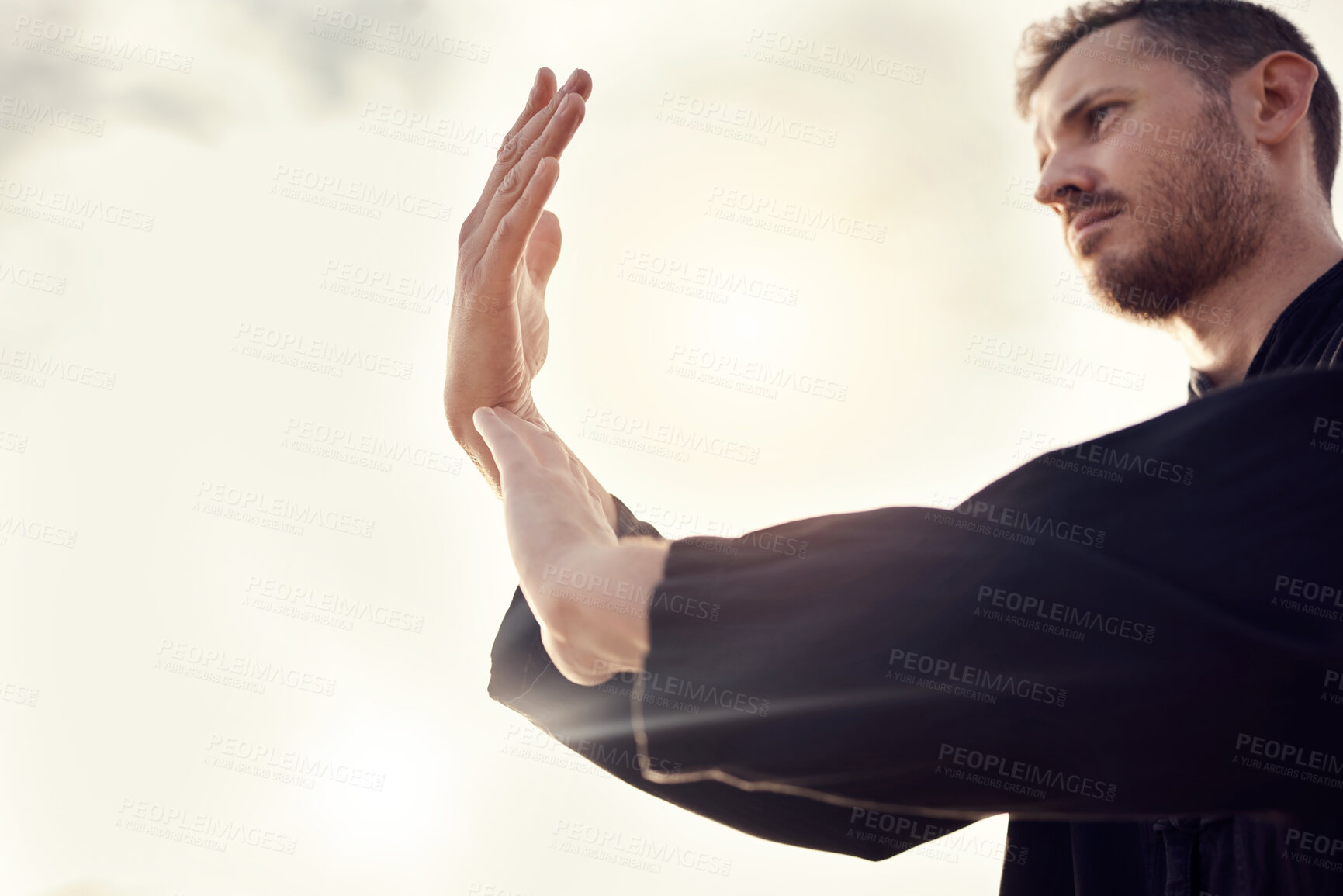 Buy stock photo Karate, tai chi wellness or man on beach, sea or ocean for zen, fitness training or sports health in sunset lens flare. Focus, mindset or athlete for chakra exercise, peace or defense workout outdoor