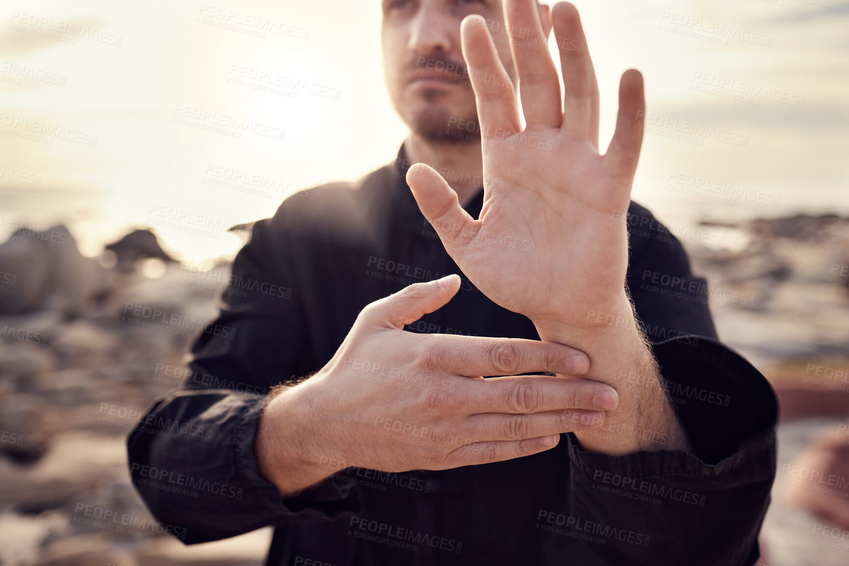 Buy stock photo Tai chi, hand and man on the beach practicing spiritual and meditation activity for peace and zen mind. Chi gong, gesture and male teacher for meditative sport and asian martial art exercise