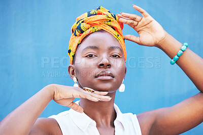 Buy stock photo Fashion, Africa and portrait of black woman on blue background with natural beauty, glowing skin and makeup. Hands frame face of girl with African style or design cosmetics, head scarf and jewellery