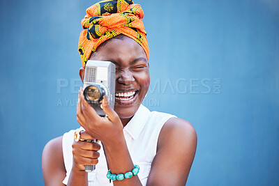 Buy stock photo Face, photographer and black woman with camera in studio isolated on a blue mock up background. Photography, tech and happy female from Nigeria with camcorder taking pictures, photo or photographs.