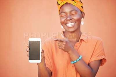 Buy stock photo Phone screen, mockup and african woman with fashion website, sales promotion and marketing space for product placement, branding or logo. Orange wall, hand holding cellphone and a Nigeria black woman
