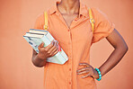 Black woman, hands and text books for education, learning or classroom study in orange background in studio, school or university campus. Student, library or reading information material for research