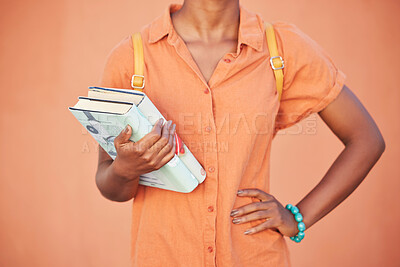 Buy stock photo Black woman, hands and text books for education, learning or classroom study in orange background in studio, school or university campus. Student, library or reading information material for research