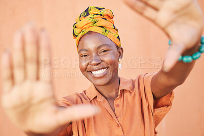 Buy stock photo Fashion black woman, face or framing hands on orange wall background in city for profile picture, Congo branding or clothing advertising. Portrait, smile or happy model in photography pov with turban