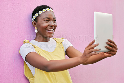 Buy stock photo Tablet selfie, smile and happy black woman with picture memory of flower crown, beauty and vacation in South Africa. Spring fashion, online social media post and girl with digital tech on pink wall