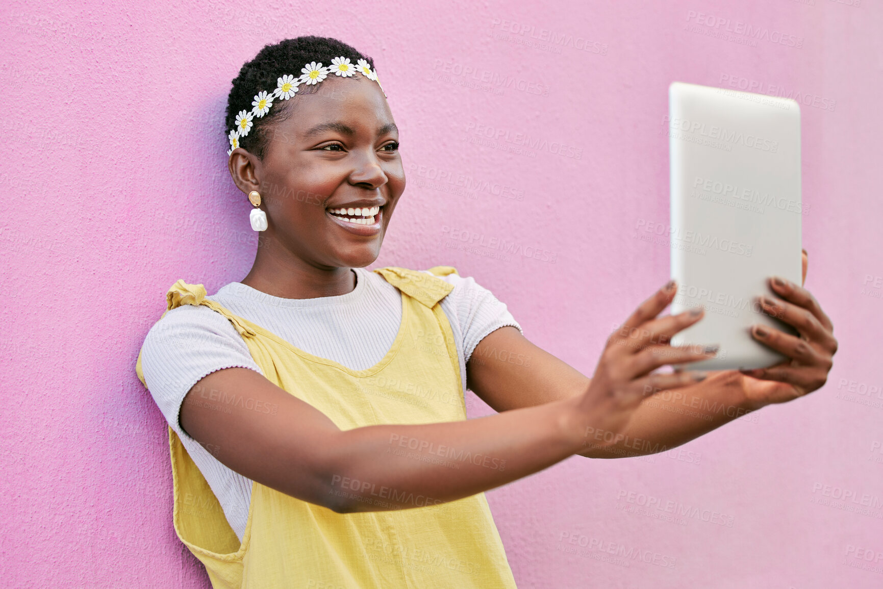 Buy stock photo Tablet selfie, smile and happy black woman with picture memory of flower crown, beauty and vacation in South Africa. Spring fashion, online social media post and girl with digital tech on pink wall