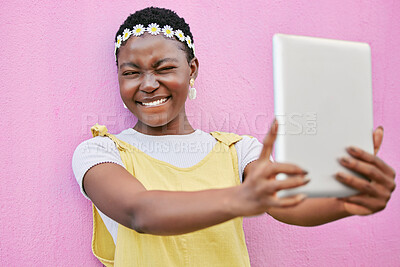 Buy stock photo Digital tablet selfie, African and black woman post picture memory to social media, online web app or social network. Beauty flower crown, facial expression and tech girl with spring fashion on wall