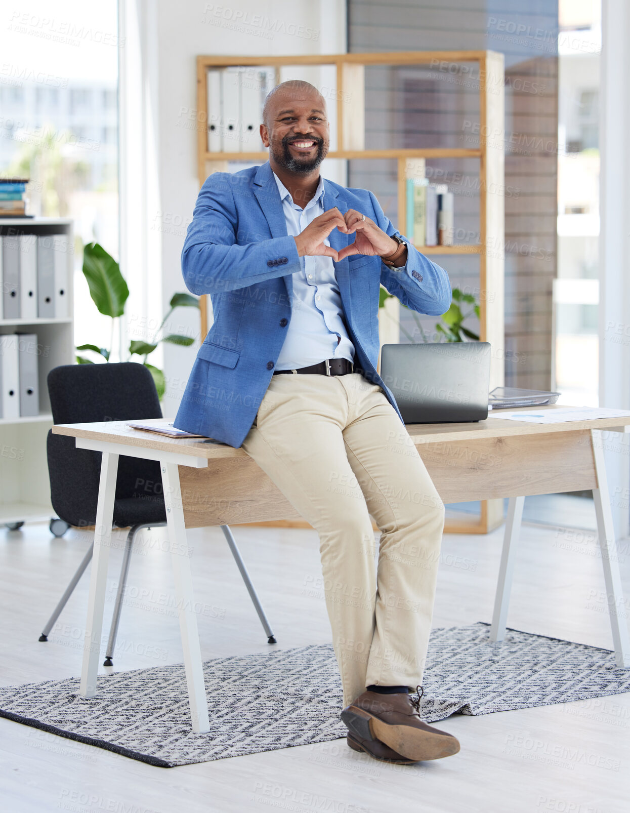 Buy stock photo African businessman, heart sign or office for smile, happiness or sitting on desk with love. Black man, corporate executive or finance job with hands signal, care or solidarity for support in Atlanta