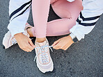 Sports, shoes and woman legs for running, training or workout on asphalt road or urban street with fitness fashion for health or wellness. Runner getting ready on ground for exercise with sneakers