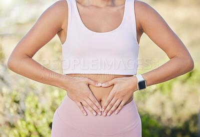 Buy stock photo Hands, stomach and fitness of woman with diet, lose weight and wellness goals in park, nature and outdoor healing, training or yoga. Exercise, workout and gut health of girl with digestion hand sign