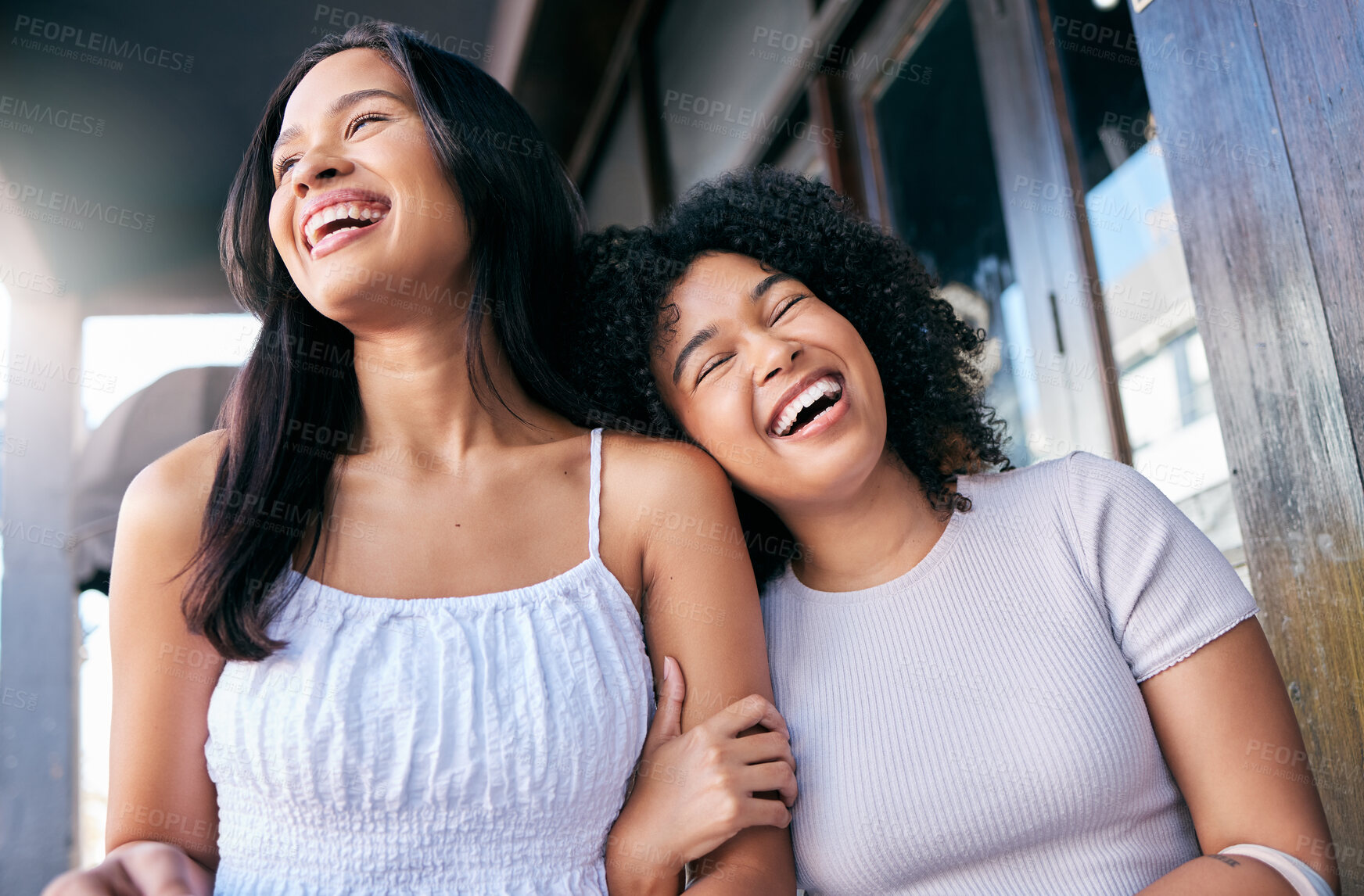 Buy stock photo Friends, laughing and women hug in a loving, caring relationship in the city for fun happiness. Black women, walking and travel in an urban town with love, care and embrace affection with humour