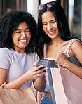 Shopping,  friends and women with phone in the mall enjoying freedom, quality time and weekend together. Shopping bags, smartphone and young girls laughing at meme online, social media and internet