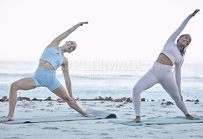 Buy stock photo Yoga, women and stretching on beach in the morning, balance and fitness for wellness, health or peace outdoor. Young females, girls and meditation for breathing, relax and workout for zen on seaside.