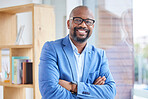 Motivation, vision and mindset with a business black man CEO, manager or boss standing arms crossed in the office. Portrait, glasses and mission with a mature male employee leaning against a window