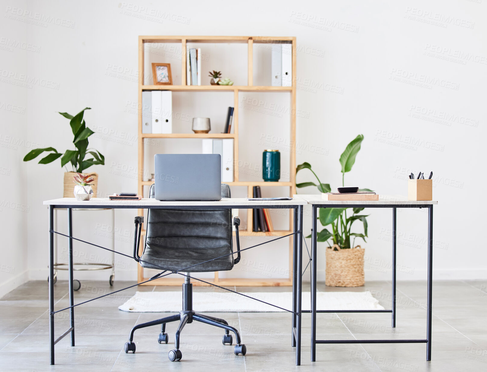 Buy stock photo Empty office, table or desk in a home office interior or office desk with pens, plants or stationery for productivity. Furniture, chair or modern office room with laptop or folders in a wooden shelf