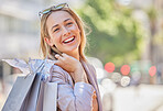 Woman, happy portrait and shopping bag walking  in city for retail therapy, fashion promotion or customer happiness. Clothes market success, smile and shopper freedom in New York street mall boutique