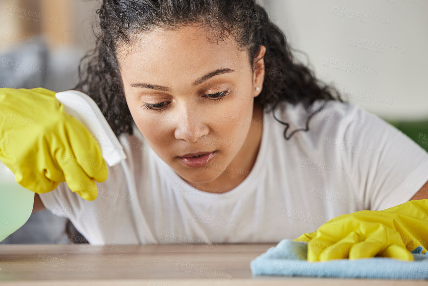 Buy stock photo Home, housework and woman with spray bottle cleaning table or counter with detergent in living room. House, maintenance and girl in clean fresh house, housekeeping with gloves and spring clean work.