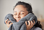 Happy, woman and fresh laundry in home with satisfied smile on face feeling clean wool sweater. Happiness, wellness and hygiene of girl cleaning in laundry room at house touching soft texture.

