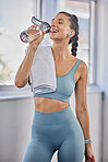 Fitness, exercise and woman with water bottle in gym after workout, bodybuilding training and pilates. Sports, wellness and female athlete drinking water for hydration, detox and healthy lifestyle