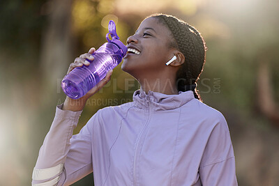 Buy stock photo Exercise, black woman and drinking water for fitness, wellness and health outdoor to relax. Sports, young female Nigerian and athlete hydration, liquid for break and training for workout and earbuds.