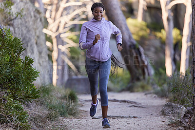 Buy stock photo Fitness, nature and black woman running for exercise with endurance, focus and health in a forest. Sports, athlete and African lady doing cardio workout or training for race, marathon or competition.