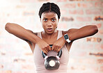 Black woman, fitness and kettlebell with focus and exercise in gym, weights and muscle training with strong athlete and bodybuilding. Bodybuilder, workout and sport motivation with wellness portrait.