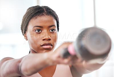 Buy stock photo Fitness, kettlebell and black woman doing an exercise with a weight with strength, focus and motivation. Sports, exercising and strong African female athlete doing muscle training or workout at a gym