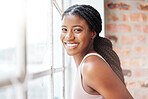 Face portrait, black woman and smile in gym by window after workout, training or exercise. Sports, wellness or happy female athlete from Nigeria in fitness center on break after exercising for health