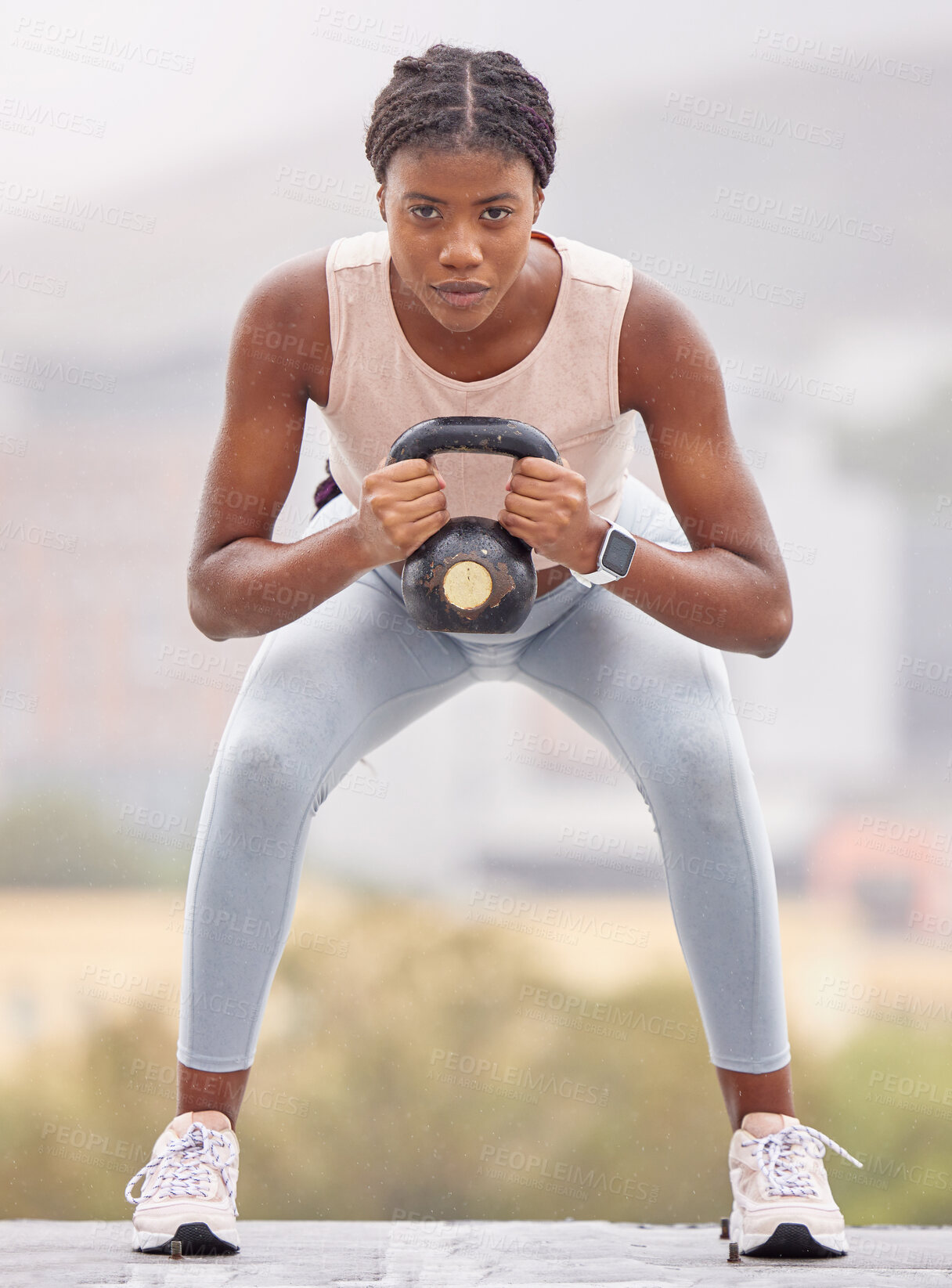 Buy stock photo Fitness, squat and black woman with weight in the city, exercise energy and training for health on a rooftop in Turkey. Wellness, strength training and portrait of a girl with a kettlebell for muscle