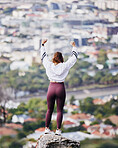 Fitness, celebration and woman on mountain with arms raised for victory, achievement and exercise goals. City, wellness and back of happy girl excited after running, marathon training and workout