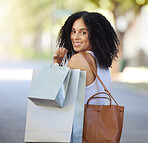 Portrait, fashion and black woman with shopping bag in city after buying clothing at mall. Black Friday deals, sales discount or happy female shopper holding gifts after purchase at boutique or store