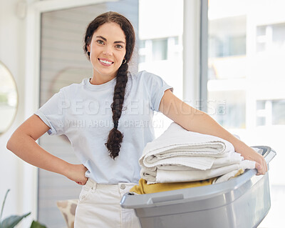 Buy stock photo Woman, laundry basket and home portrait in lounge, room and cleaning for service, chores and smile. Happy cleaner, clothes or clean fabric for hygiene, care or job in house, apartment or living room