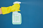 Hand, spray and detergent for cleaning, hygiene or anti bacteria chemical against a blue studio background. Hands of glove spraying liquid bottle for washing, clean sanitary or disinfection on mockup
