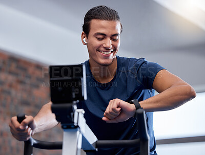 Buy stock photo Fitness, bike and man doing workout at the gym for cardio endurance, health and wellness. Sports, electric bicycle and healthy male athlete training or doing exercise with smart watch in sport center