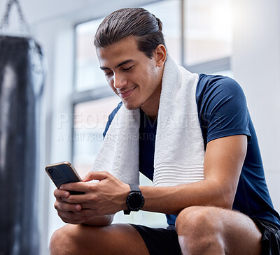 Buy stock photo Fitness, phone and man relax in gym tracking workout, exercise or progress on app. Tech, sports and happy male with towel and mobile smartphone for internet browsing,  text messaging or social media.