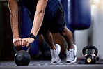 Exercise, kettlebell and strong hands man doing gym workout with a fitness watch during muscle training as bodybuilder with metal weights. Athlete with smartwatch to train for power and health goals