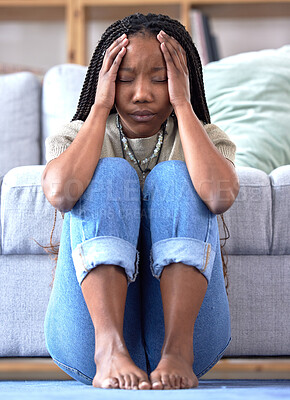 Buy stock photo Black woman, headache and stress on floor in home for mental health, depression and frustrated student for university burnout. Depressed, college anxiety and african girl tired or pain in living room